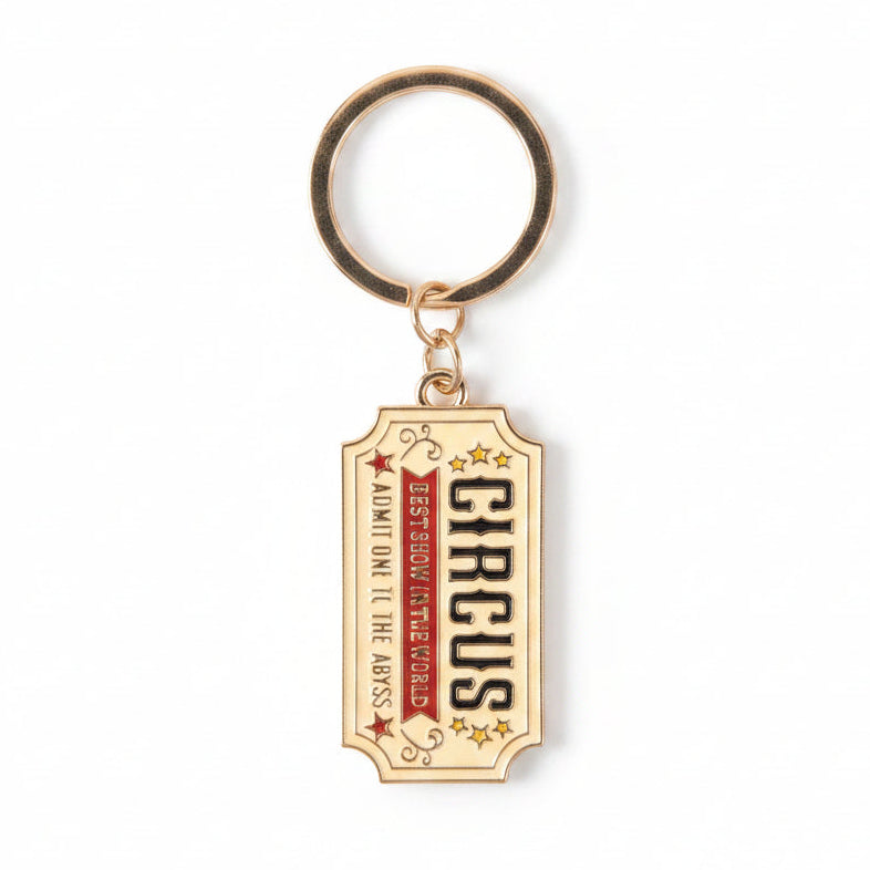 Close-up of circus ticket keyring on white background