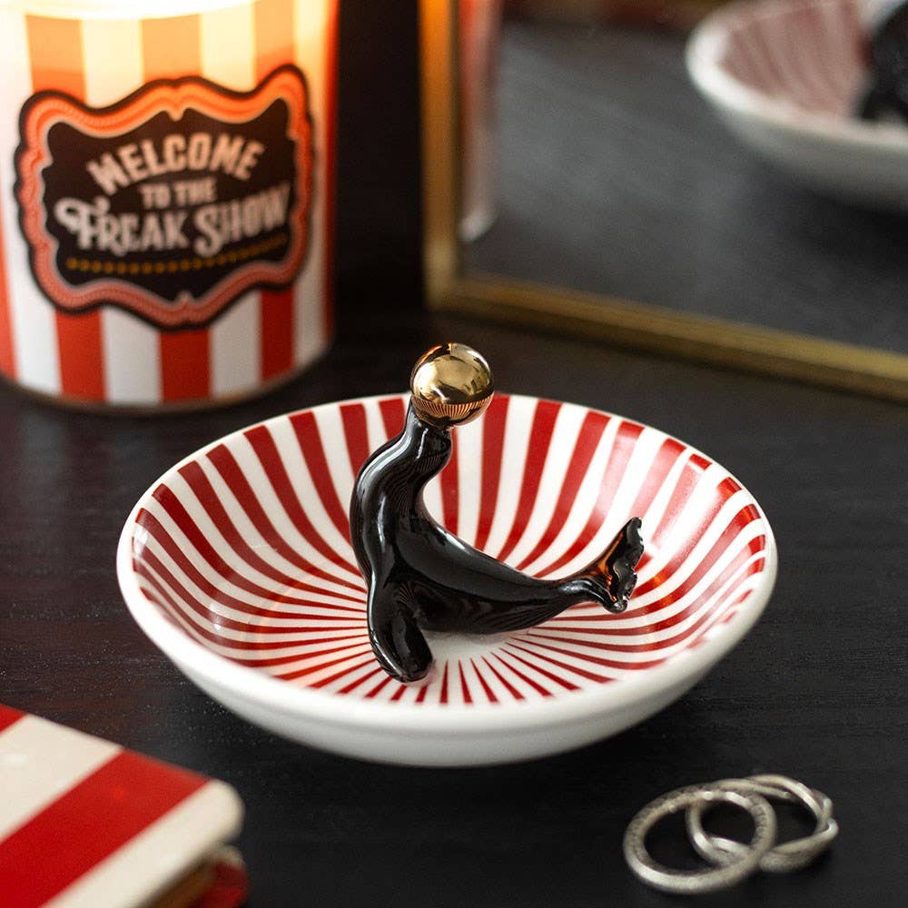Seal trinket dish with red/white stripes on dark moody background