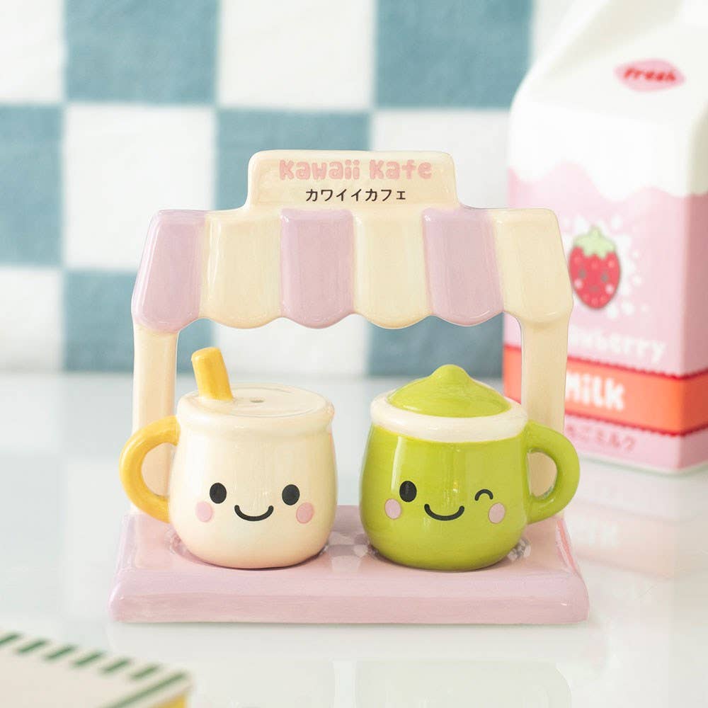 Two kawaii mugs in pink café stand on pink packaging