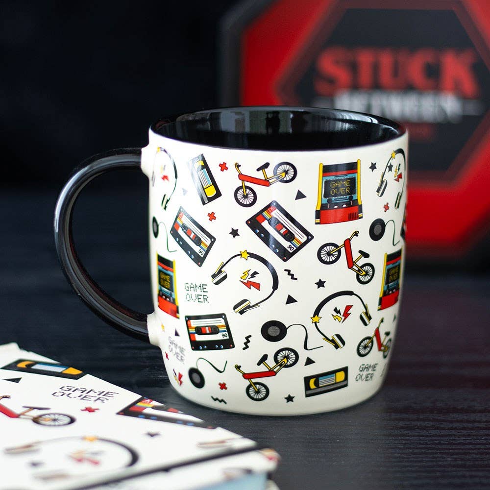 Mug with retro 80s print on dark background with candle