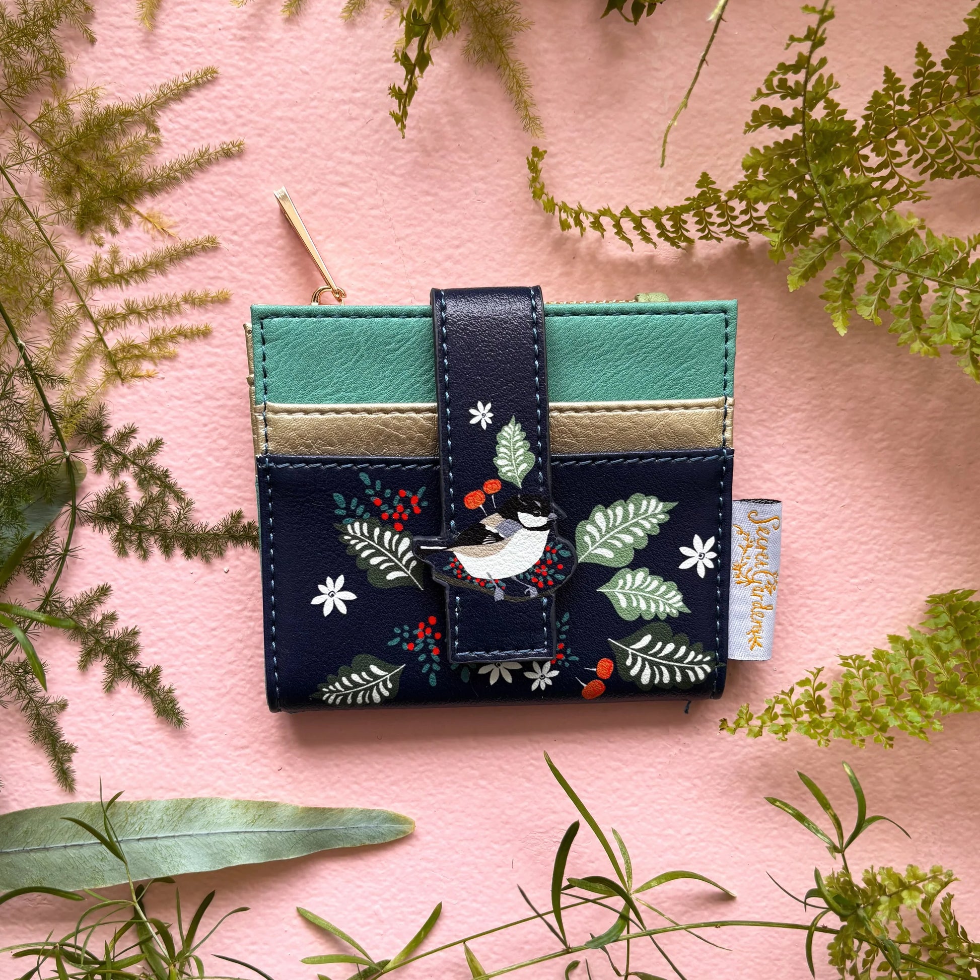 Secret Garden bird purse in navy faux leather on pink background