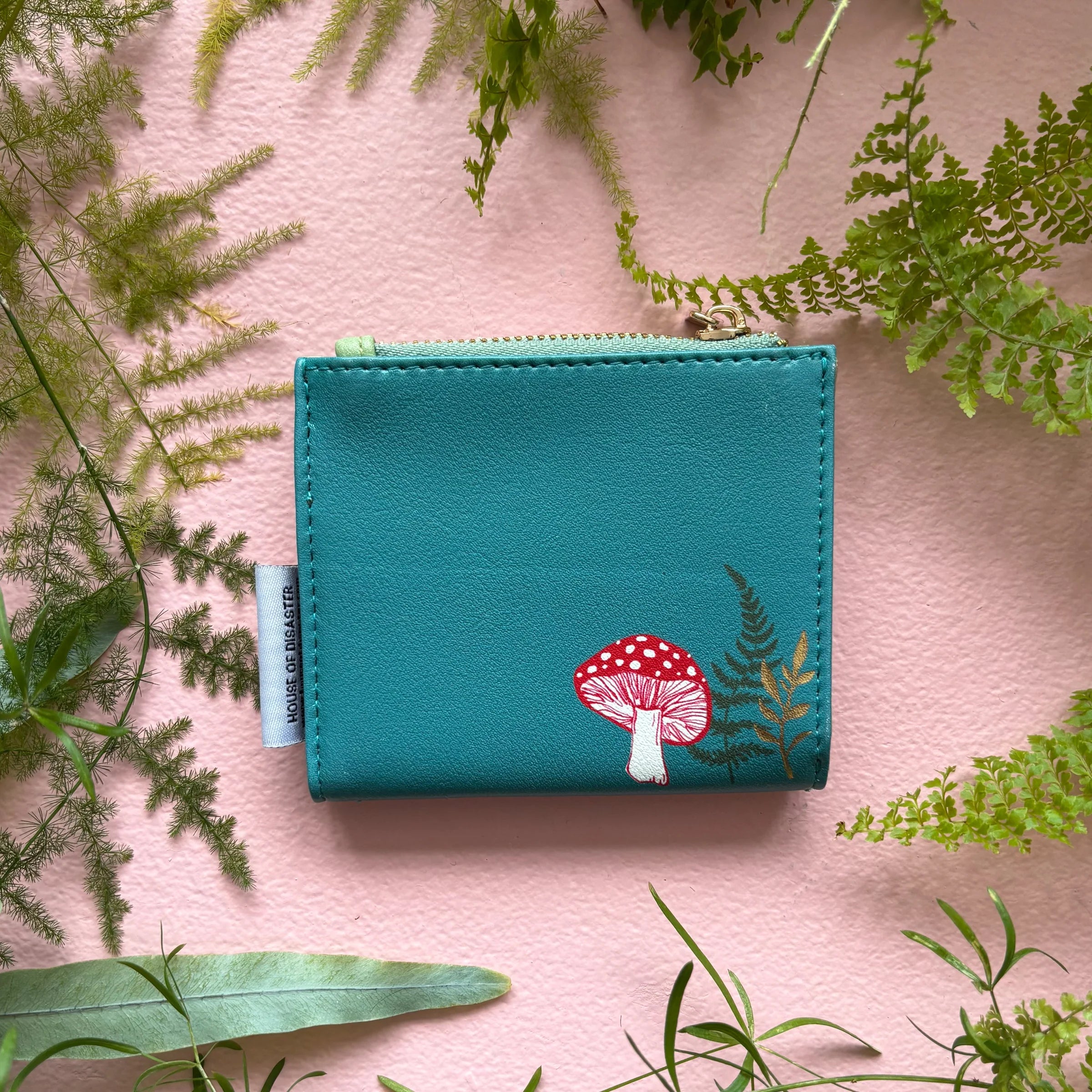 Back view of hedgehog purse with mushroom illustration