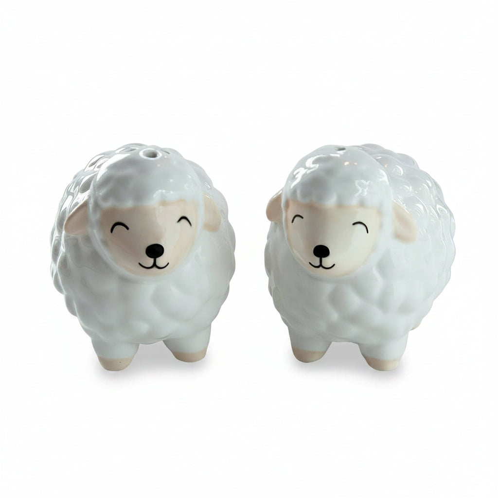 Ceramic sheep shakers showing happy closed eye faces and pink ears