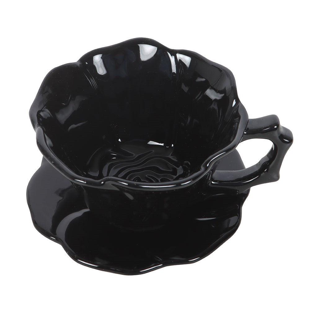 Black rose teacup and saucer at an angle showing interior