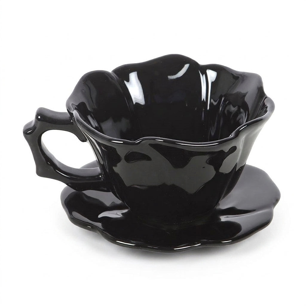 Gothic black rose teacup and saucer on a white background
