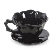 Gothic black rose teacup and saucer on a white background