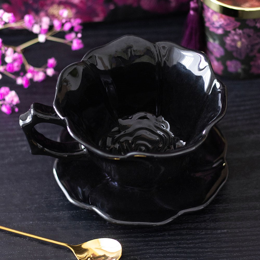 Black rose teacup and saucer styled with pink blossoms