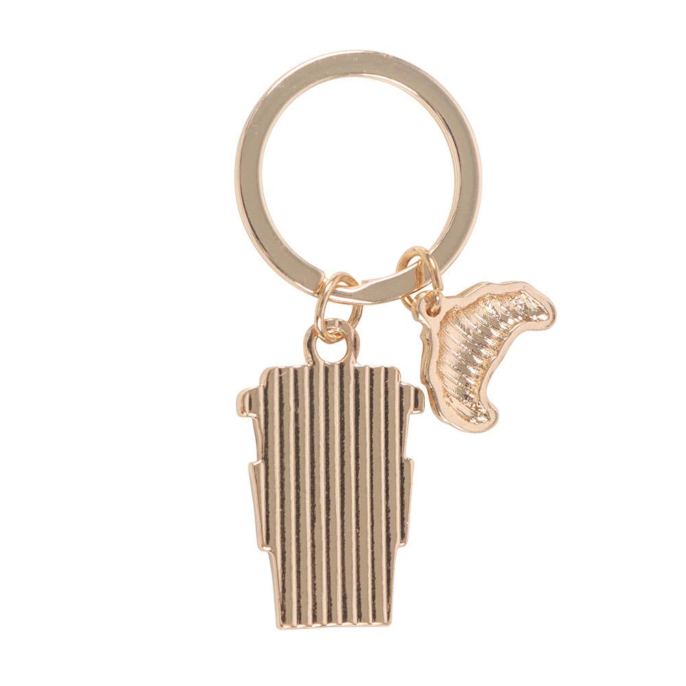 Back view of gold-toned coffee cup and croissant keyring charms on white