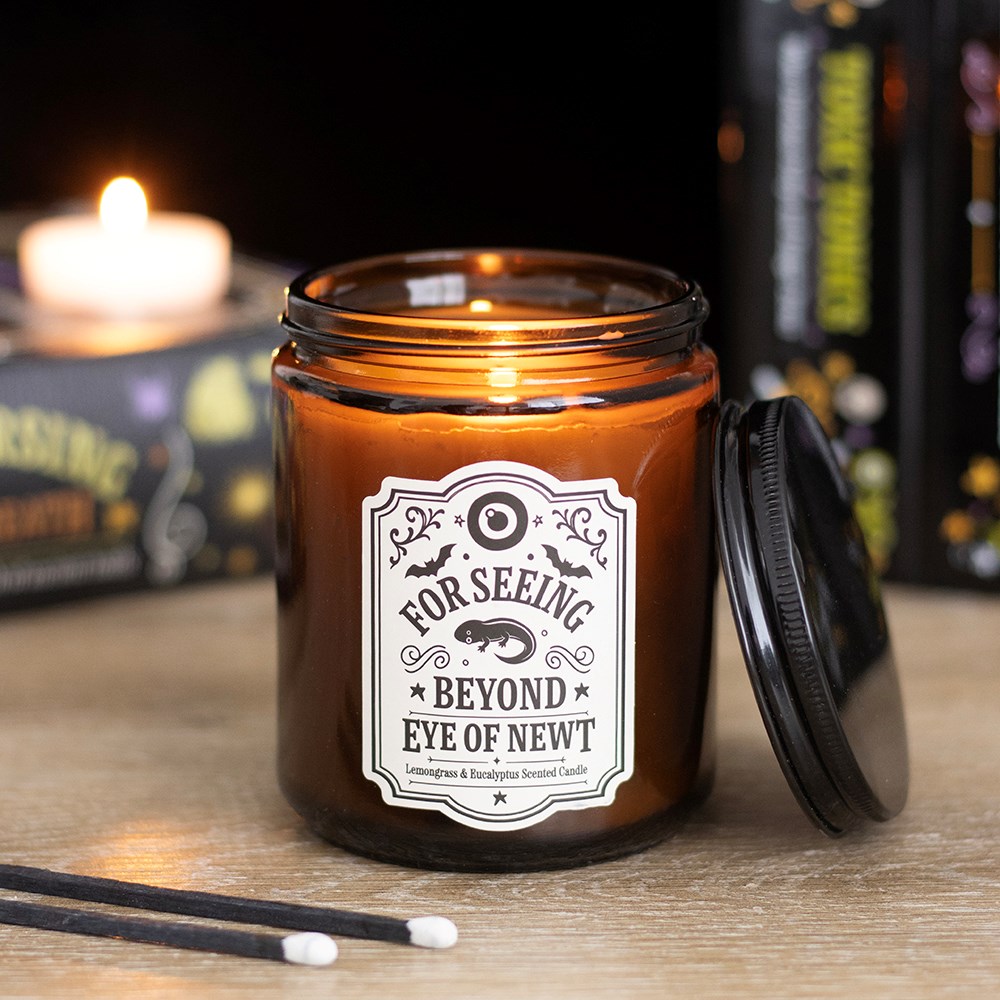 Lit Eye of Newt candle styled with Halloween decor