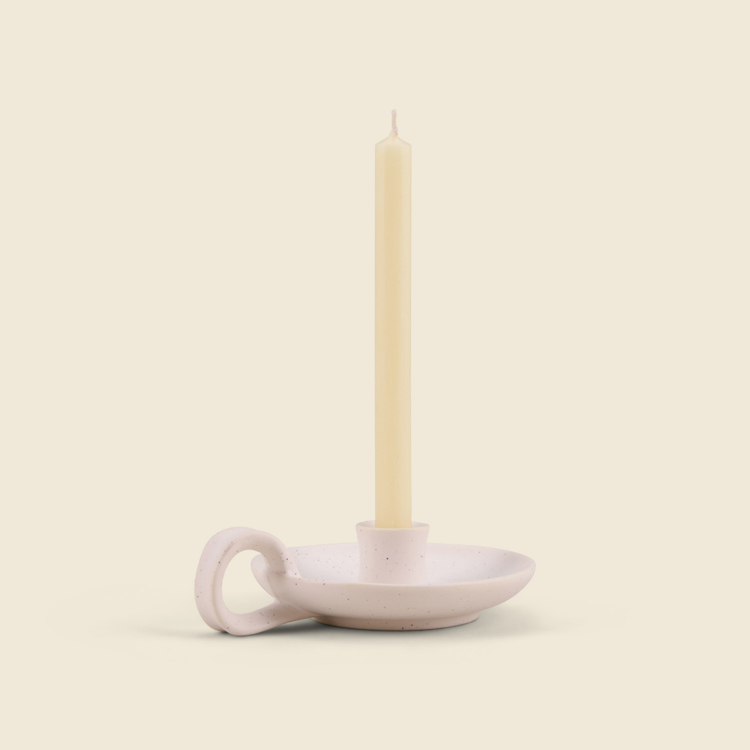 Inspiritus mini ivory candle in a white speckle holder, cream background