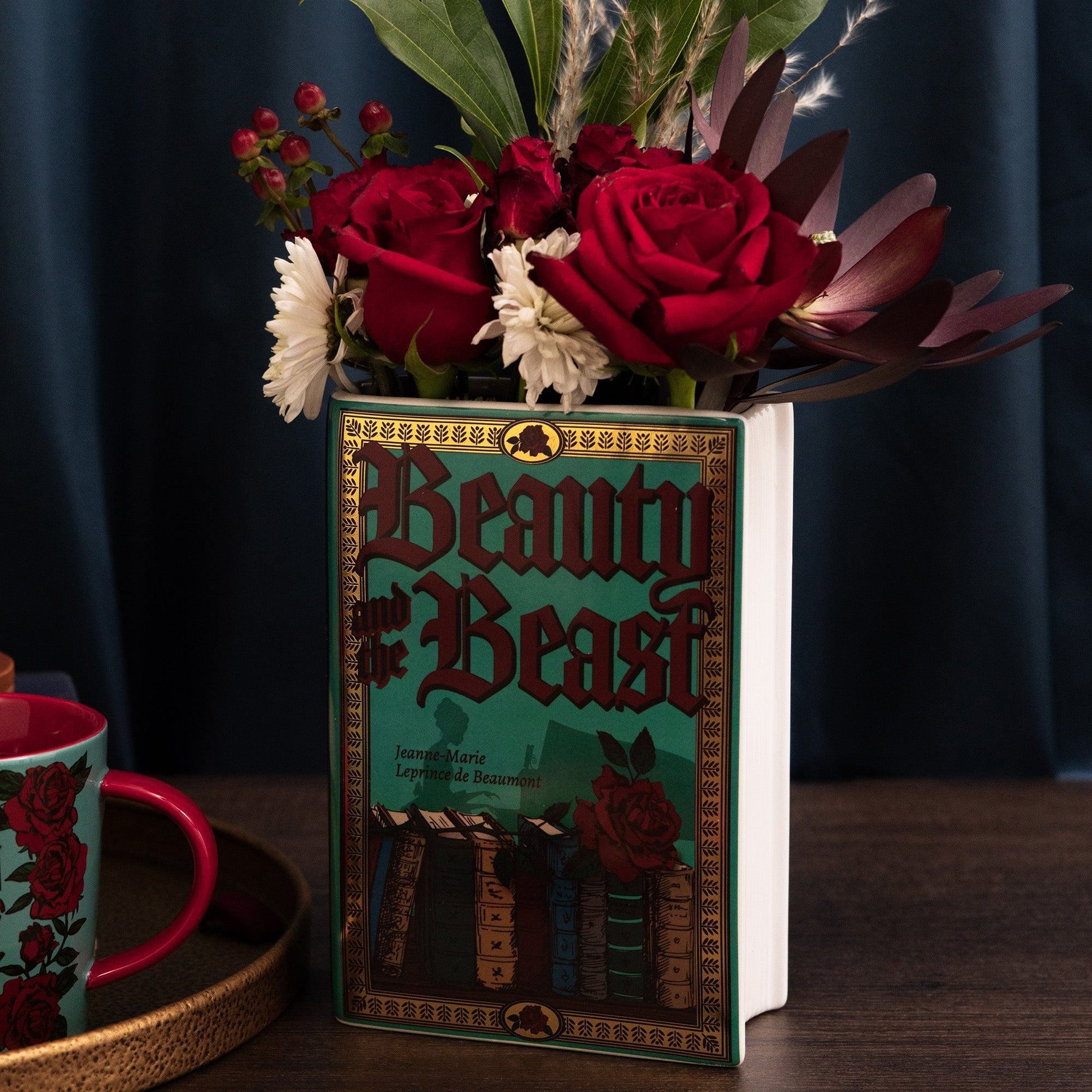 Teal Beauty and the Beast book vase holding flowers