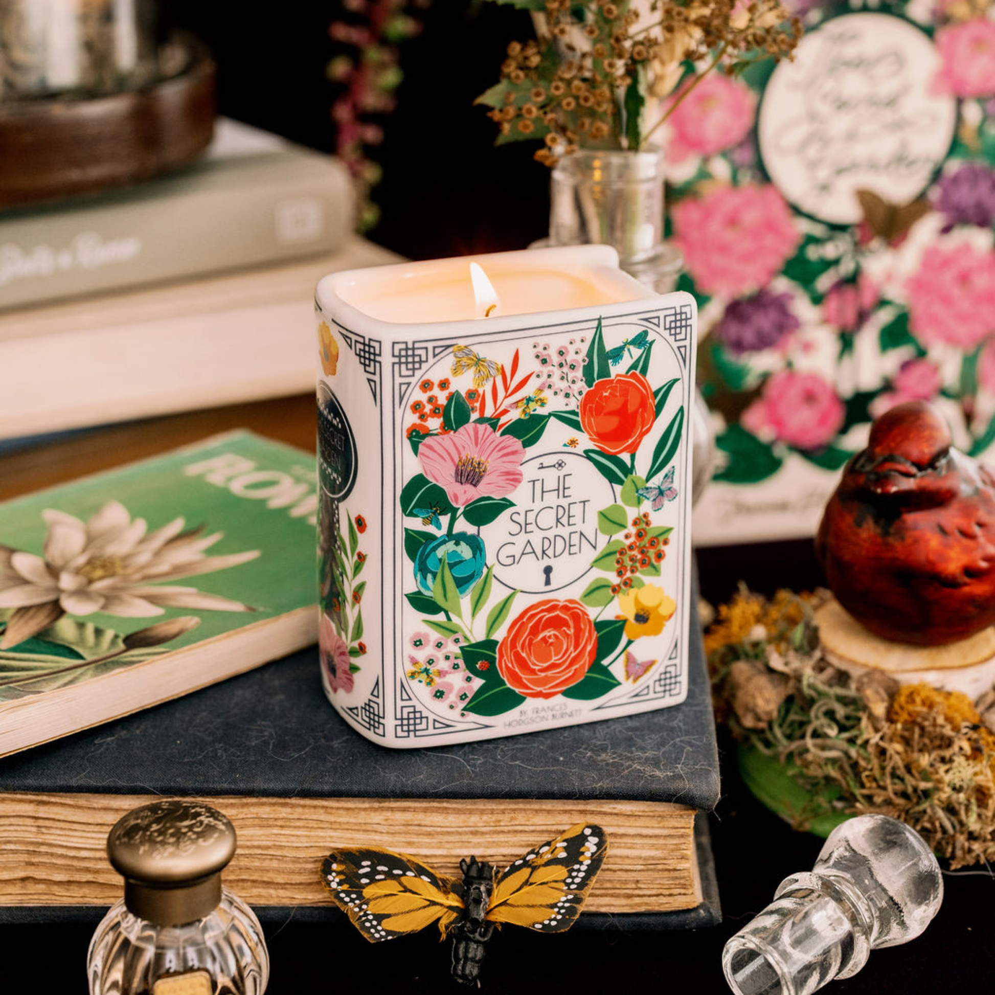 Secret Garden book candle lit and styled with flowers and a butterfly