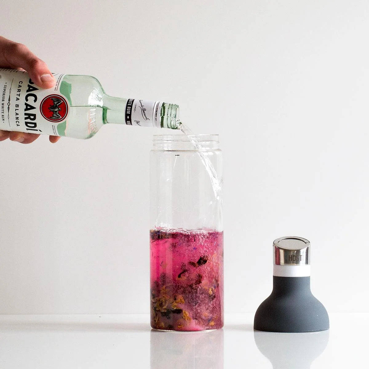 Rum being added to Strawberry Daiquiri Mix for infusion.