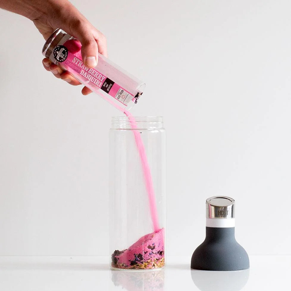 Pink Strawberry Daiquiri Mix being poured into a jug.