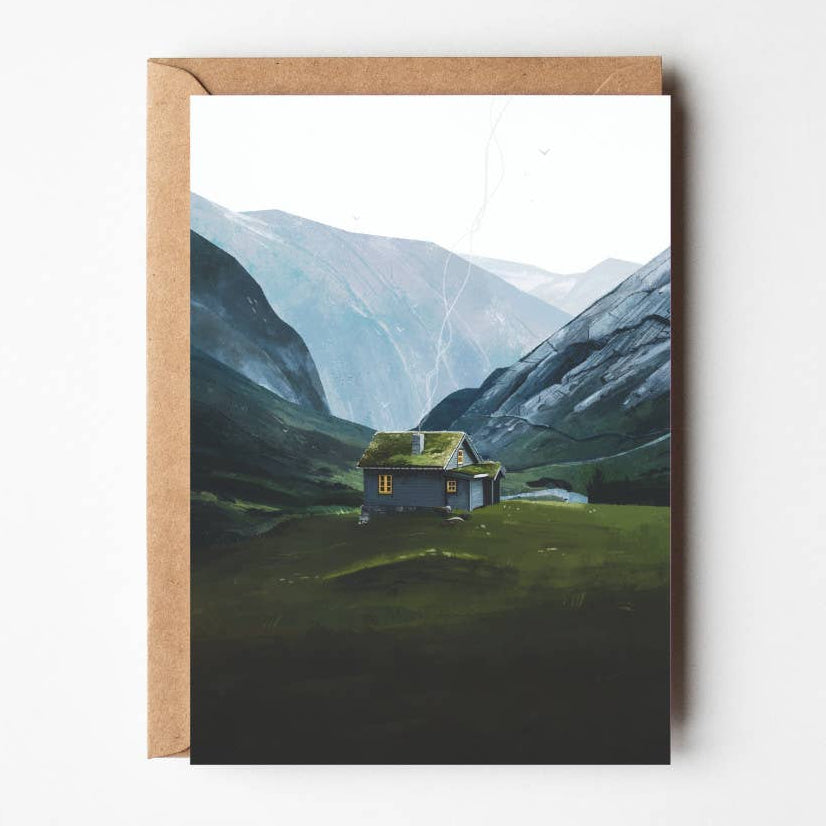 Stryn Sæter greeting card featuring illustrated Nordic cabin in green valley with mountains, paired with kraft envelope.