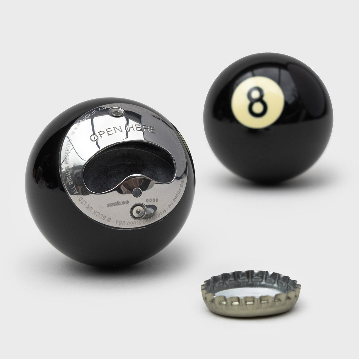 8 ball bottle opener front and back with a bottle cap, grey background
