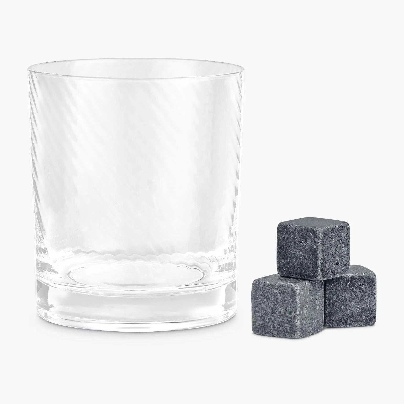 Twisted Whiskey Glass with three granite whisky stones beside it.