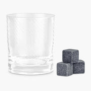 Twisted Whiskey Glass with three granite whisky stones beside it.