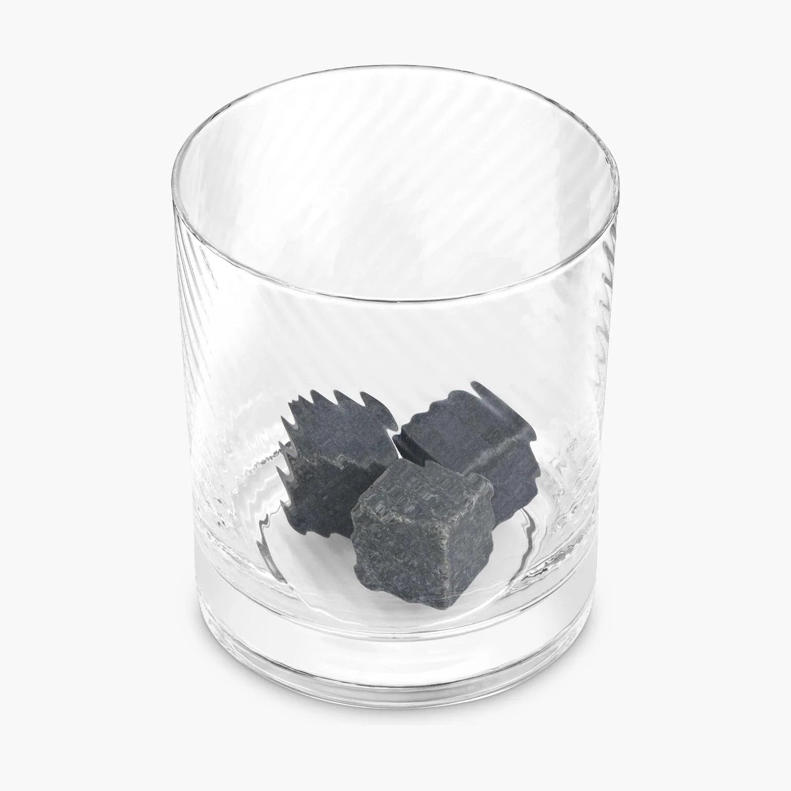 Twisted Whiskey Glass with whisky stones inside on white background.