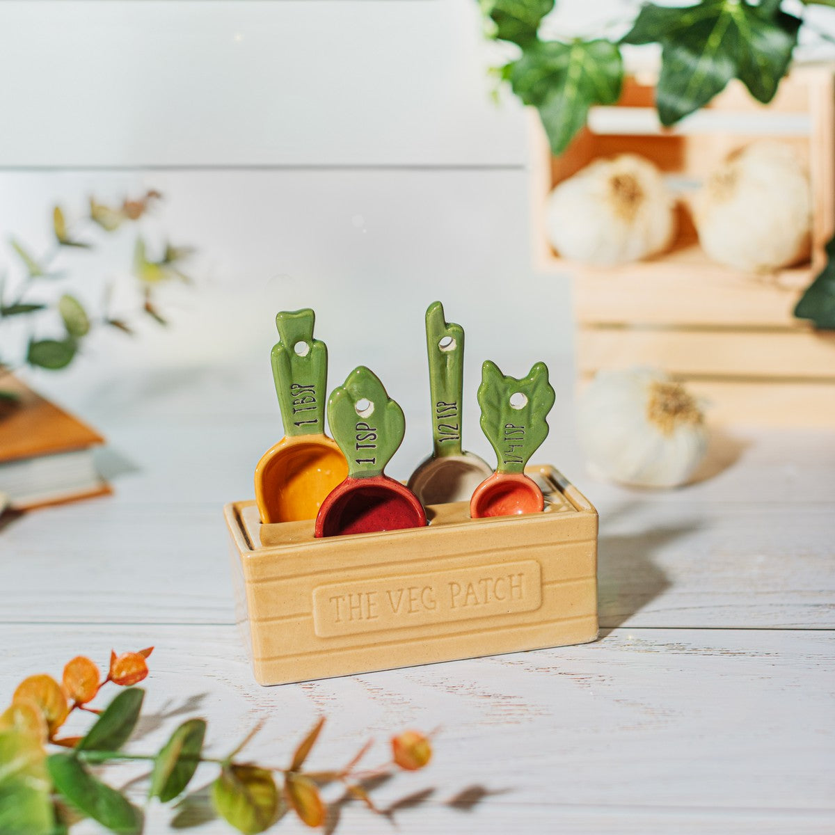 Vegetable ceramic measuring spoons in veg patch holder styled on a kitchen worktop