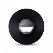 Black vinyl bottle opener shaped like a record on white background