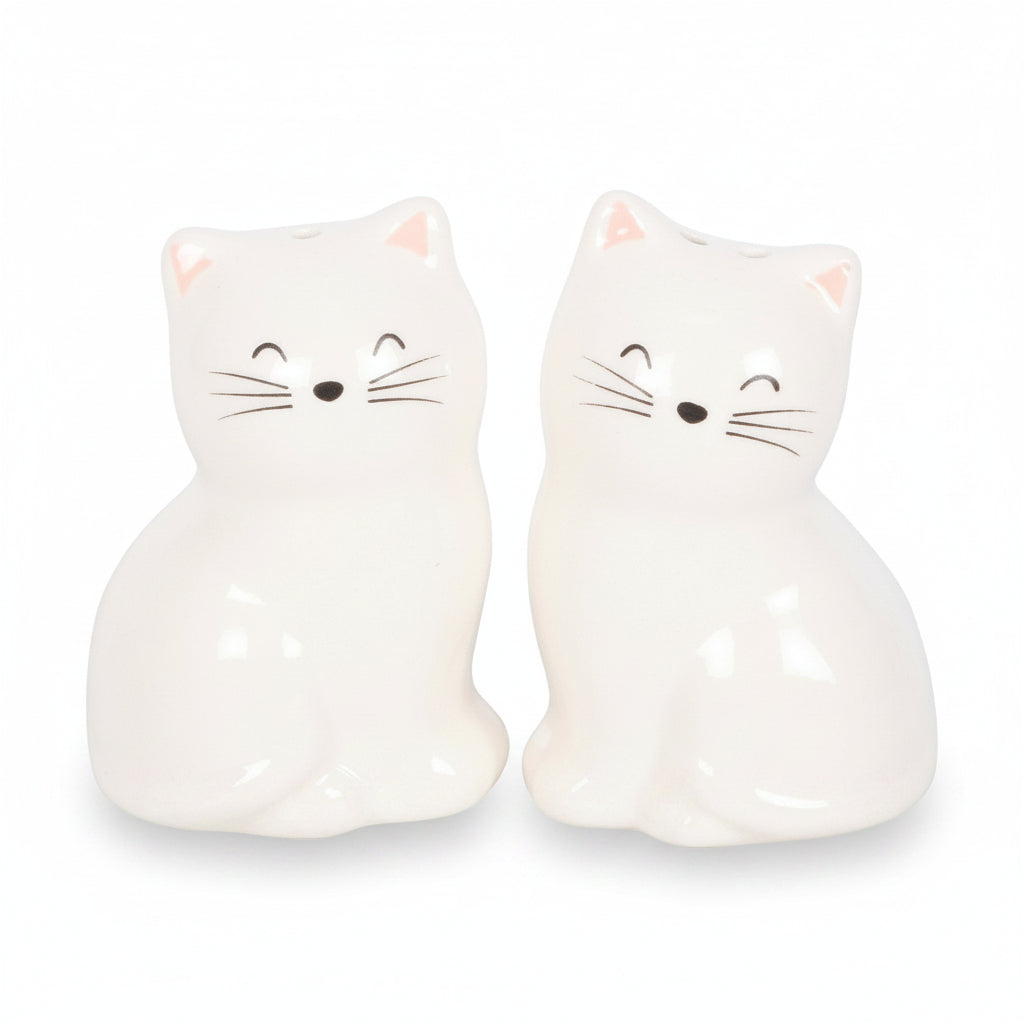 White cat shakers showing closed eyes whiskers and pink ears detail