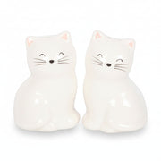 White cat shakers showing closed eyes whiskers and pink ears detail