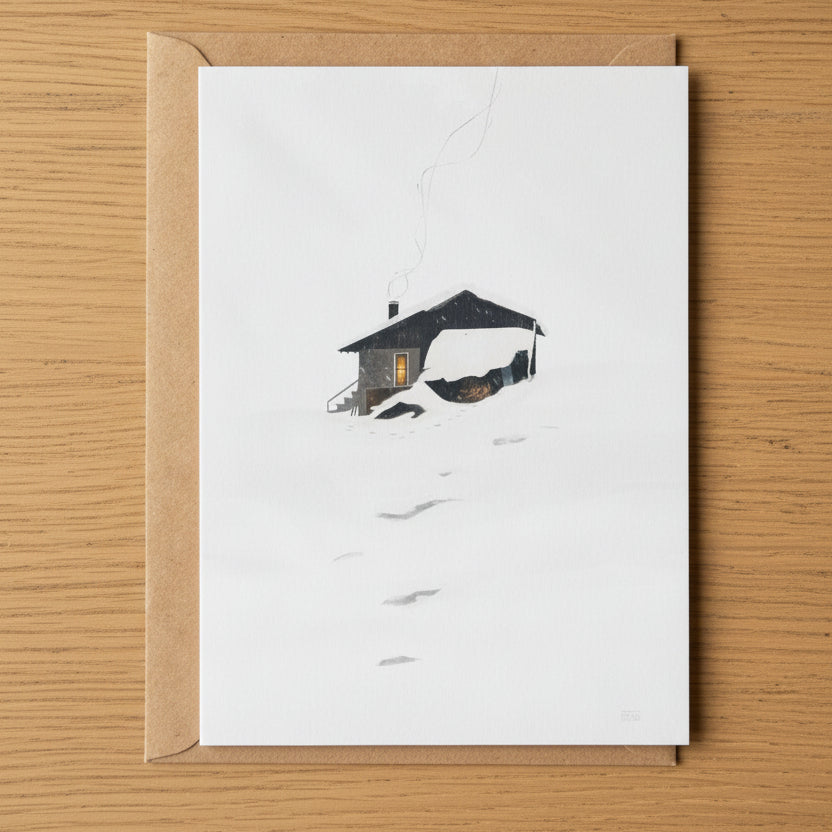 Winter Hide greeting card featuring Sara Willia's snowy Nordic cabin artwork with kraft envelope