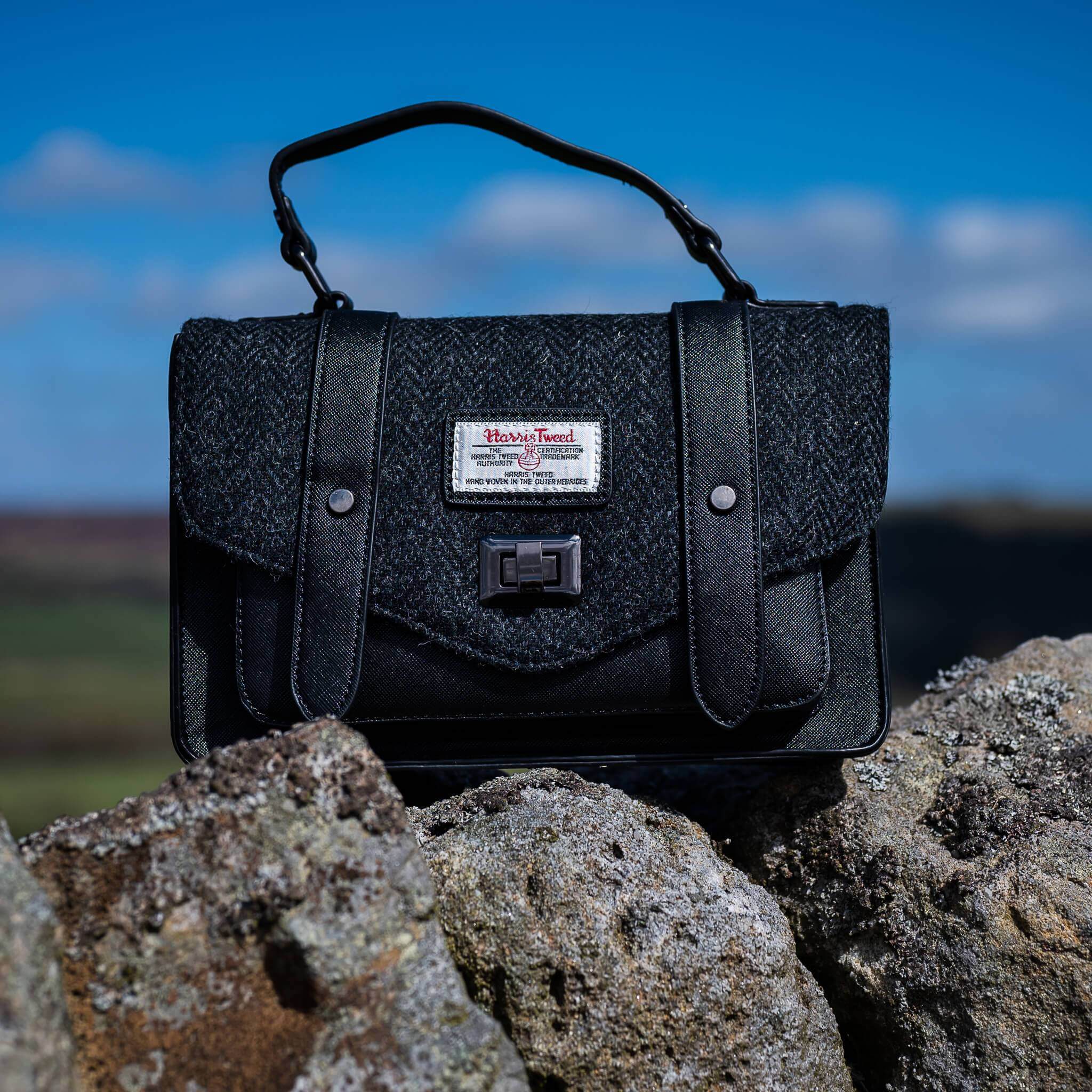 Harris Tweed satchel / handbag on top of rocks without the shoulder strap.