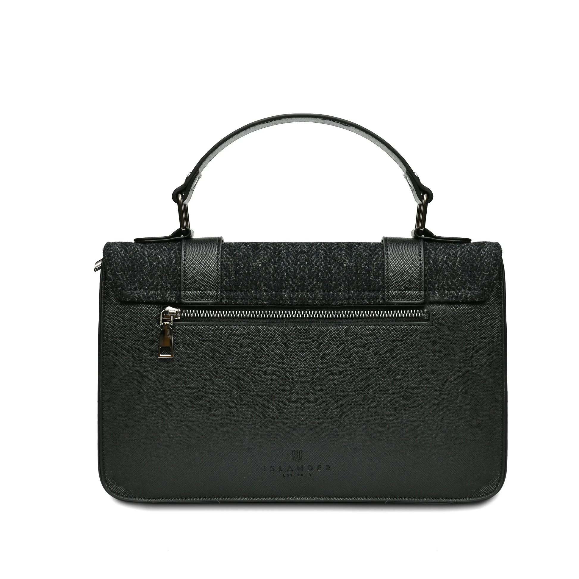 From behind showing the synthetic black leather body of the Islander Black Herringbone Harris Tweed Satchel. 